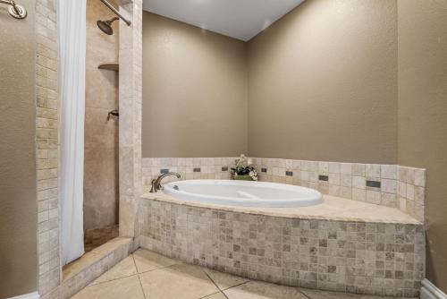 a bathroom with a bath tub in a room at CSC4L - Surfs Up in Kill Devil Hills