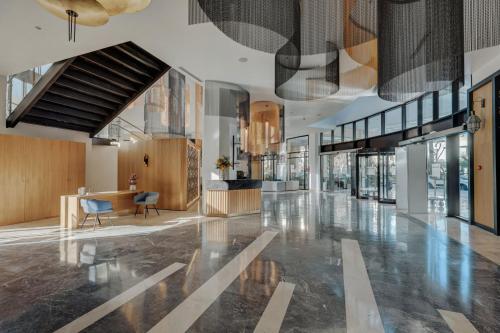 a lobby of a building with a staircase and a lobby at Barceló Fès Medina in Fez