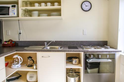 a kitchen with a sink and a counter top at Camelot Motor Lodge in Christchurch