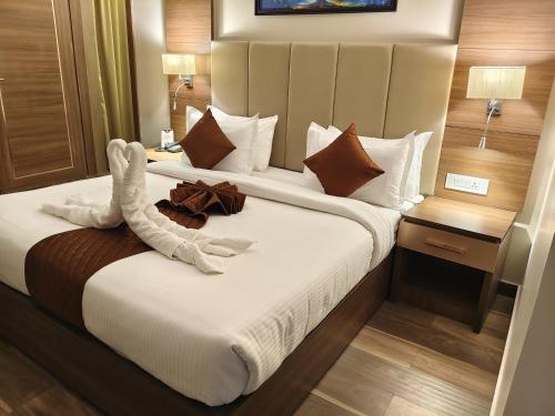 a hotel room with two beds with towels on them at Utham Mahal in Anchal