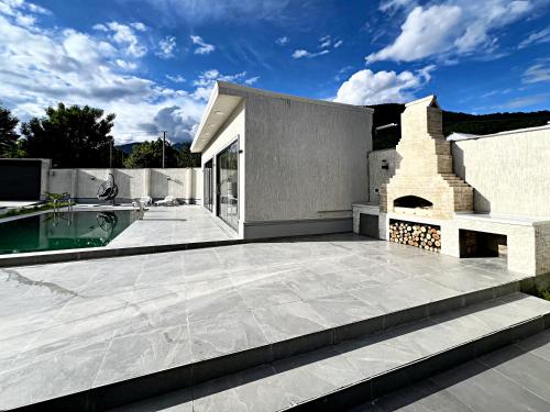 a patio with a brick fireplace on a house at Qafqaz Modern Harmony in Gabala