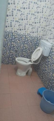 a bathroom with a toilet and a wall at shiv Ganga residence in Uttarkāshi