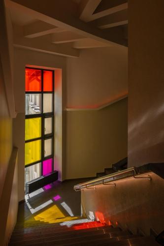 an empty room with a stained glass window at Corner Hotel in Vilnius
