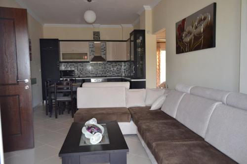 a living room with a couch and a table at Apartments Orkidea in Ksamil