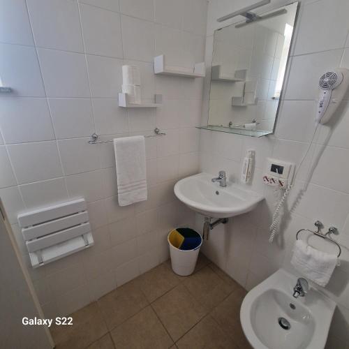 a bathroom with a sink and a toilet and a mirror at Casale Marcalia - bed & breakfast in Corigliano Calabro