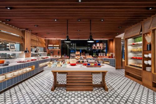 a kitchen with a large table in the middle at Four Points by Sheraton Bangkok, Sukhumvit 22 in Bangkok