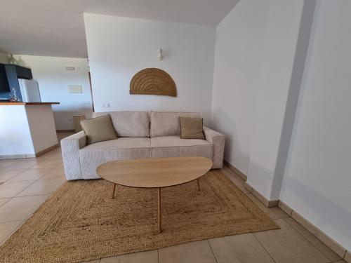 a living room with a couch and a table at Agroturismo Sa Marina - Adults Only in Cala Boix