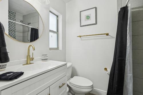 a bathroom with a sink and a toilet and a mirror at 3BR Orlando Stay Save 16 Pet-Friendly Fun in Orlando