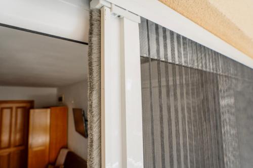 a window in a room with a curtain at Villa Katharina in Utjeha