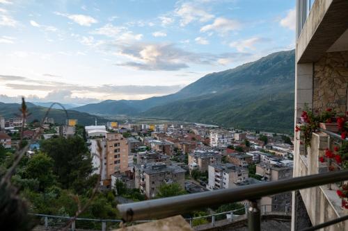 a view of a city with mountains in the background at Villa - Panoramic View of Vjosa River in Tepelenë