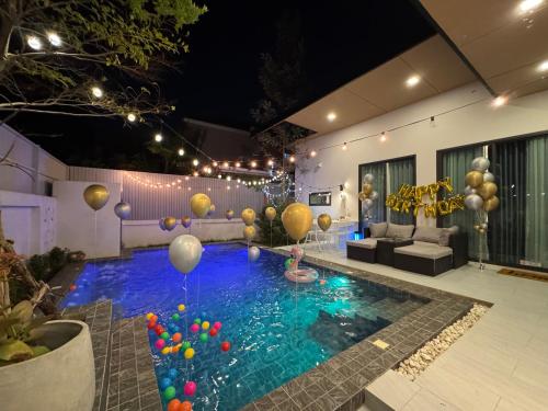 a pool with balloons in the middle of a room at nanapoolvilla ruamchok in Chiang Mai