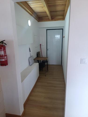 a hallway with white walls and a wooden ceiling at Casa da Miragaia in Maragaia