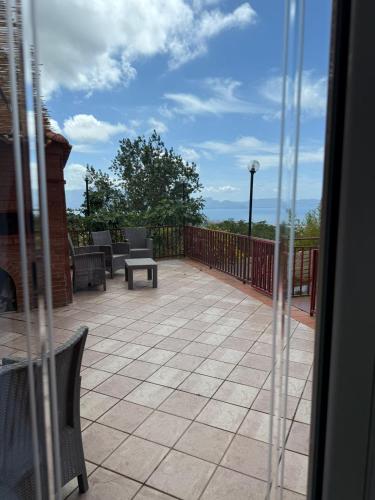 a patio with chairs and a table on a balcony at B&B Iolì Vesuvio in Ercolano