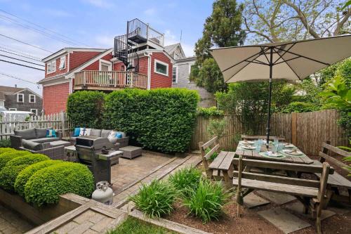 a patio with a table and an umbrella at Private Home Great Location Dog Friendly in Provincetown
