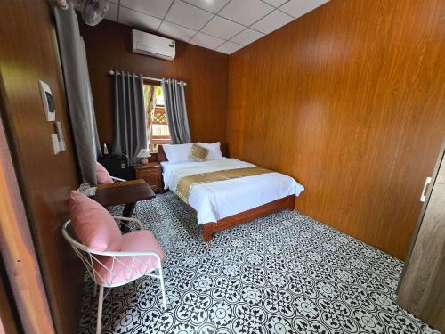 En eller flere senge i et værelse på MangoGraden Homestay