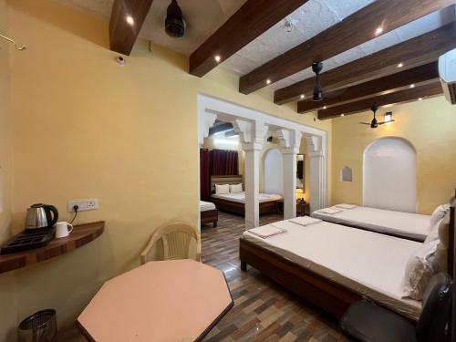 a bedroom with two beds and a room with at Foreigners Inn in Varanasi