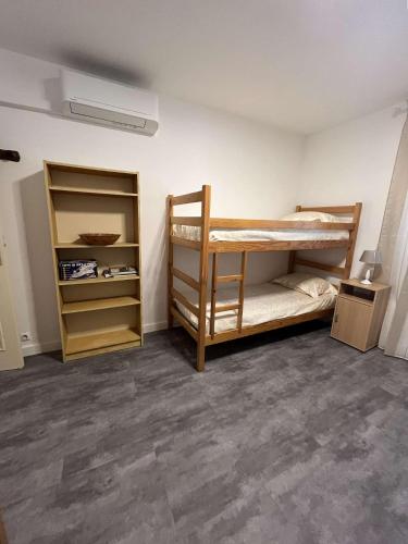 une chambre avec deux lits superposés et un placard dans l'établissement MORIANI PLAGE - Appartement climatisé proche mer, à Moriani-Plage