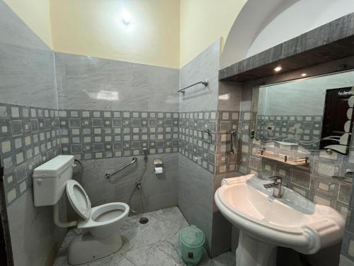 a bathroom with a toilet and a sink at Foreigners Inn in Varanasi