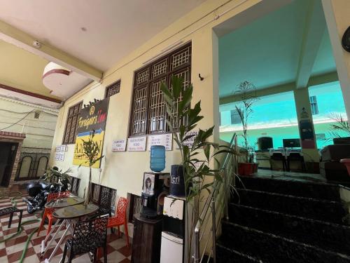 a restaurant with stairs and a table and chairs at Foreigners Inn in Varanasi