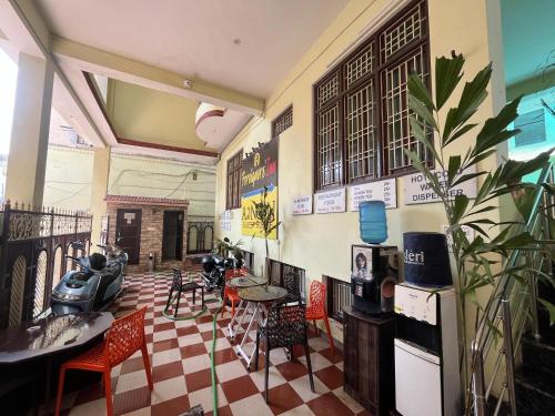 a restaurant with tables and chairs in a room at Foreigners Inn in Varanasi