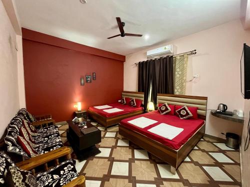 a room with two beds and a couch at Foreigners Inn in Varanasi
