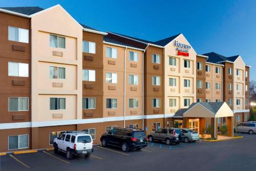 a hotel with cars parked in a parking lot at Fairfield Inn & Suites by Marriott Branson in Branson