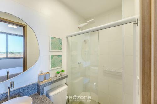 a bathroom with a shower and a toilet and a sink at Modern and sophisticated apartments near the beach in Maraú – VLL in Marau