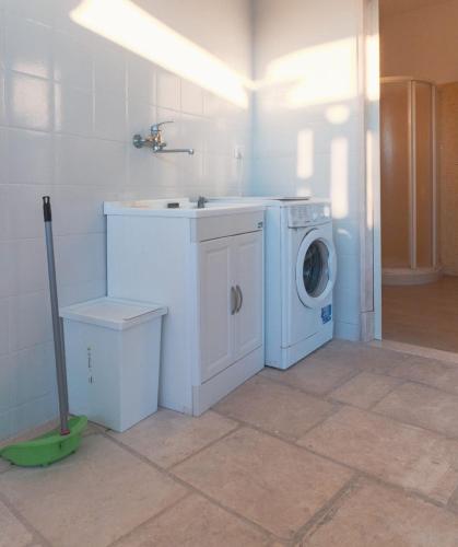 a laundry room with a washer and a washing machine at Appartamento la strea in Torre Squillace