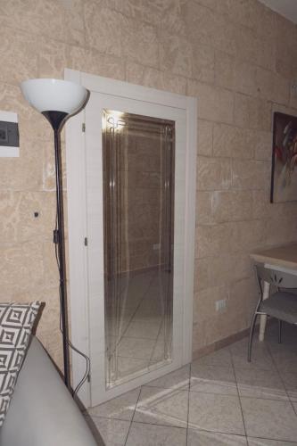 a glass door to a shower in a room at Appartamento la strea in Torre Squillace