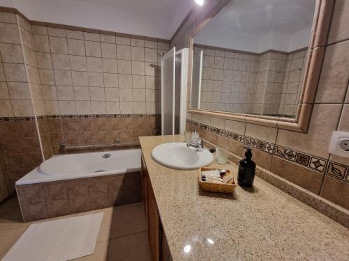 a bathroom with a sink and a bath tub at Agroturismo Sa Marina - Adults Only in Cala Boix