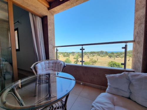 a glass table and a chair in a room with a window at Agroturismo Sa Marina - Adults Only in Cala Boix