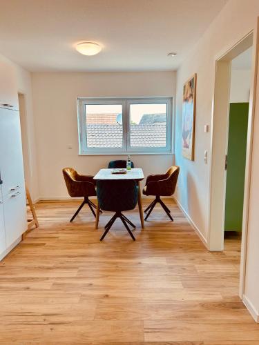 a room with a table and two chairs in it at Swiss City Apartments Rust in Rust