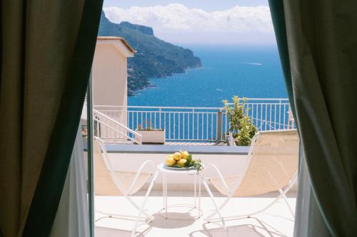 a balcony with a table with a bowl of fruit on it at Casa Dolce Casa Ravello in Ravello