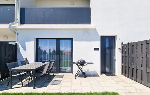 a patio with a table and a grill at Family Suite in Mörbisch am See