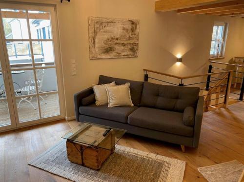 a living room with a couch and a coffee table at Ferienhaus Fachwerk Sanct Peter in Bad Neuenahr-Ahrweiler