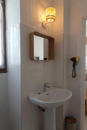 a bathroom with a sink and a mirror at HÖTEL U SANTA MARIA in Olmeto