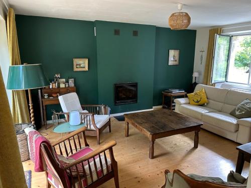 a living room with a couch and a table at Maison de charme in Pluneret