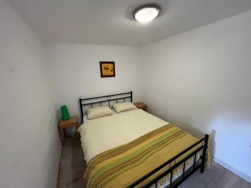 a bedroom with a bed in a white room at Couleurs de la vie - Chambres d'Hôtes et Gîte in Cormatin