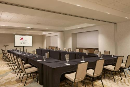 a conference room with a long table and chairs at Pittsburgh Airport Marriott in Robinson Township