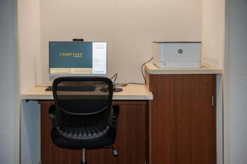 a desk with a chair and a computer on it at Courtyard by Marriott Lake City in Lake City