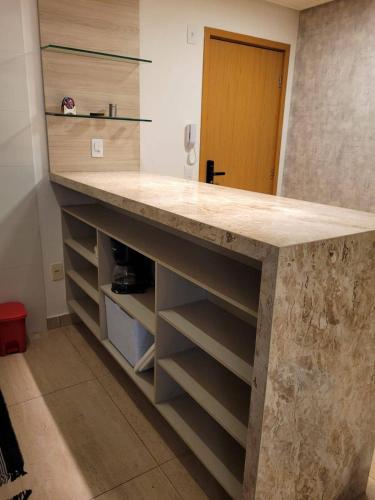 a kitchen with a marble counter top and shelves at Sol morena 1 in Conde