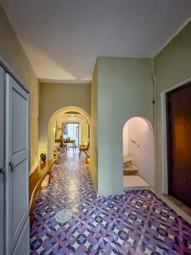a hallway with a room with a tile floor at Casa Xaca in San Miguel de Allende