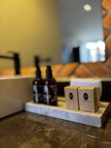 a counter top with a row of bottles on a table at Esplendor by Wyndham San Luis Potosi in San Luis Potosí