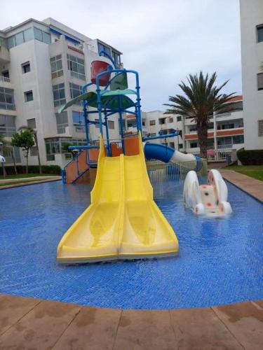 a child on a slide in a water park at La Siesta Beach Resort in Mohammedia