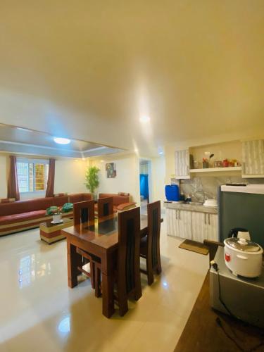 a kitchen and dining room with a table and chairs at The Cozy Cone in Baguio