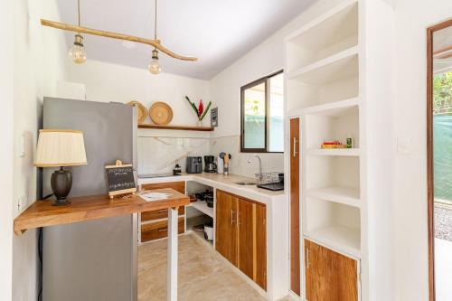 a kitchen with a desk and a sink and shelves at Casa Yute in Talamanca