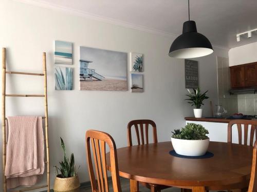 a dining room with a wooden table and chairs at Bibel Ocean Home Sunset by the sea in Vila Praia de Âncora