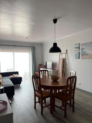 a living room with a wooden table and chairs at Bibel Ocean Home Sunset by the sea in Vila Praia de Âncora