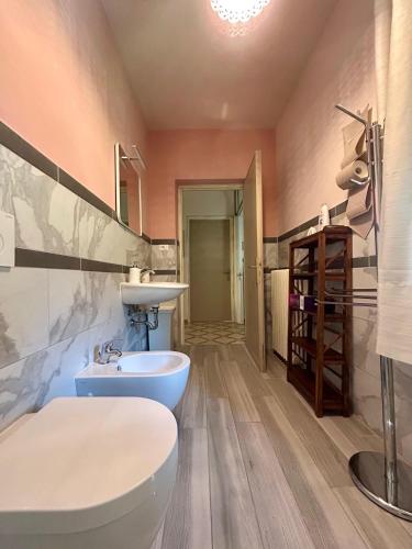 a bathroom with a white toilet and a sink at "La Casaccia" magia dei monti in Buti