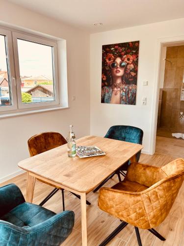 a dining room with a wooden table and chairs at Swiss City Apartments Rust in Rust